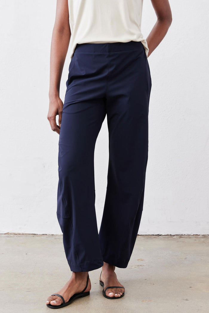 Deep navy loose work pants, side view with drawstring waist and relaxed straight legs.