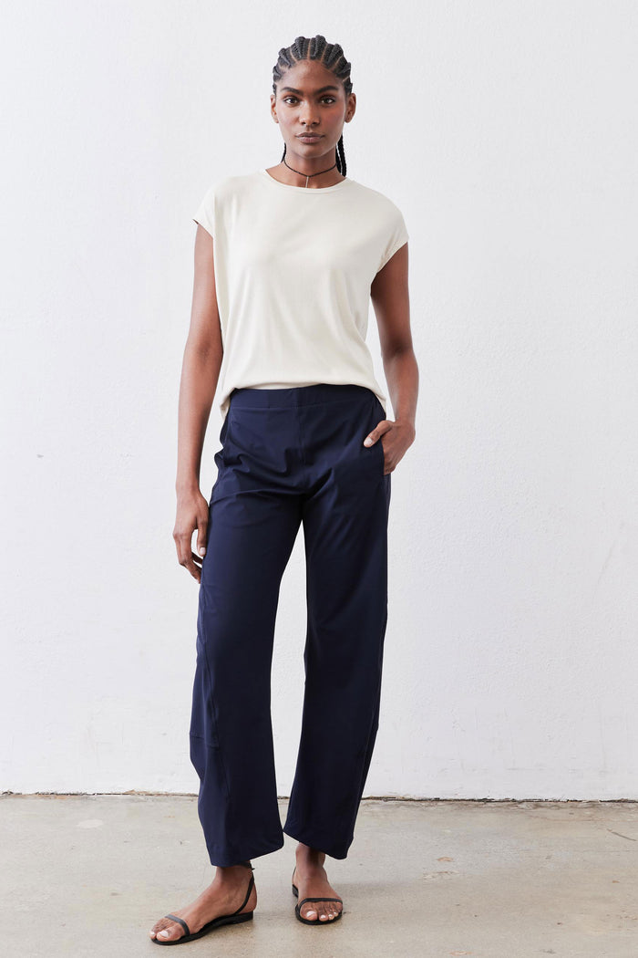 Relaxed deep navy work pants with drawstring waistband, straight ankle-length legs.