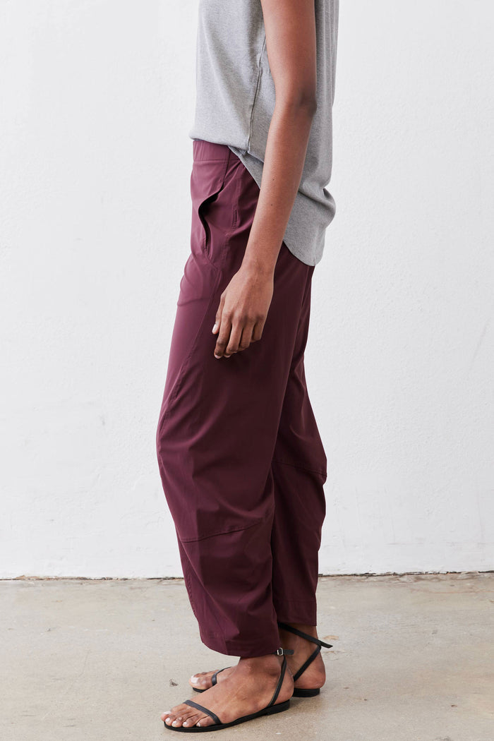 Aubergine work pants side view with elastic waistband, relaxed leg and cuffed ankle hem