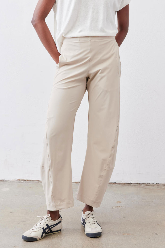 Light beige work pants with relaxed fit, ankle length, and side pockets.