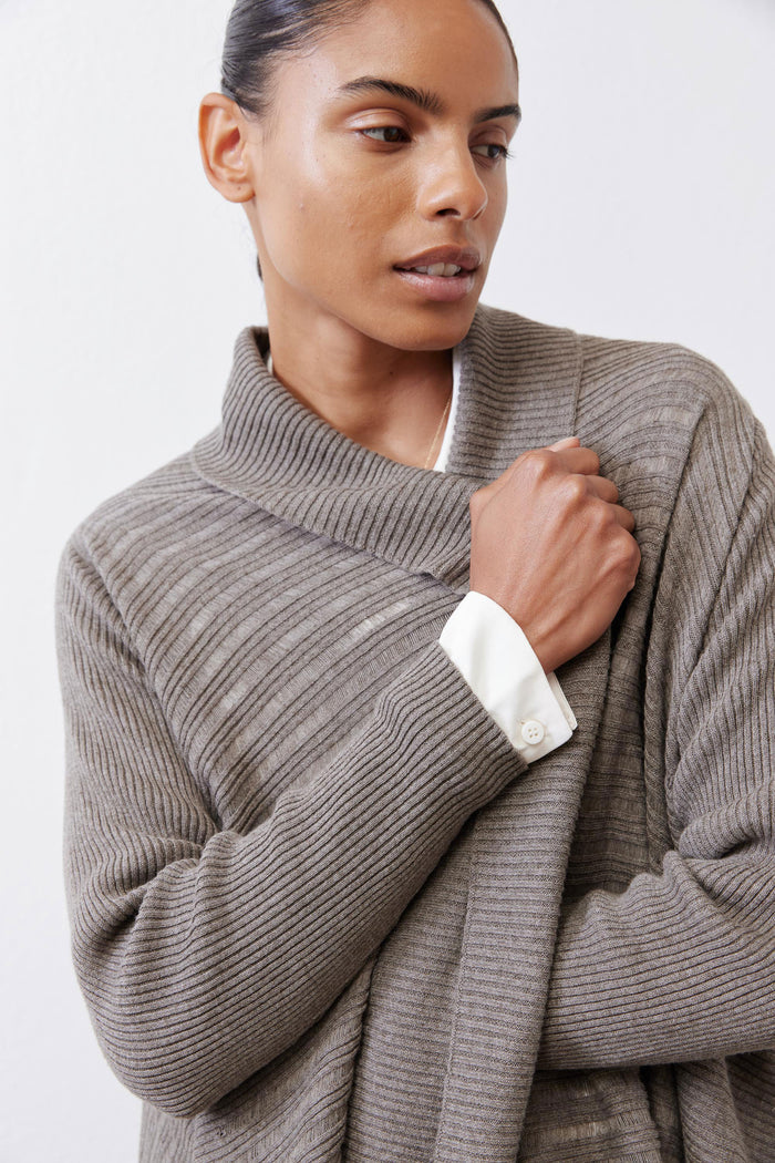 Sea gray open-knit cardigan close-up with ribbed turtleneck and long sleeves