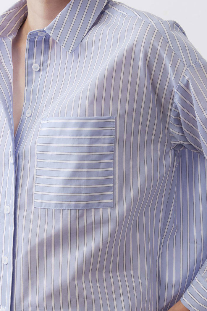 Light blue striped button-down shirt close-up with chest pocket and buttons
