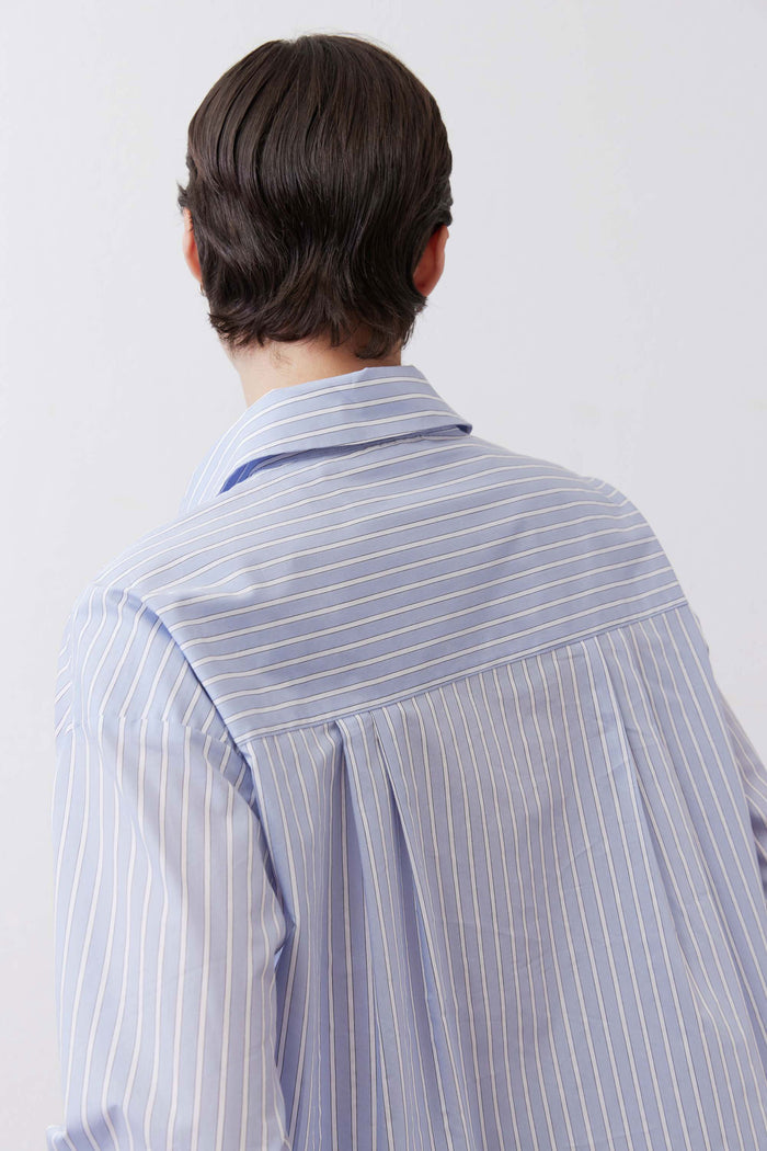 Light blue striped back of oversized button-down shirt with collar and yoke