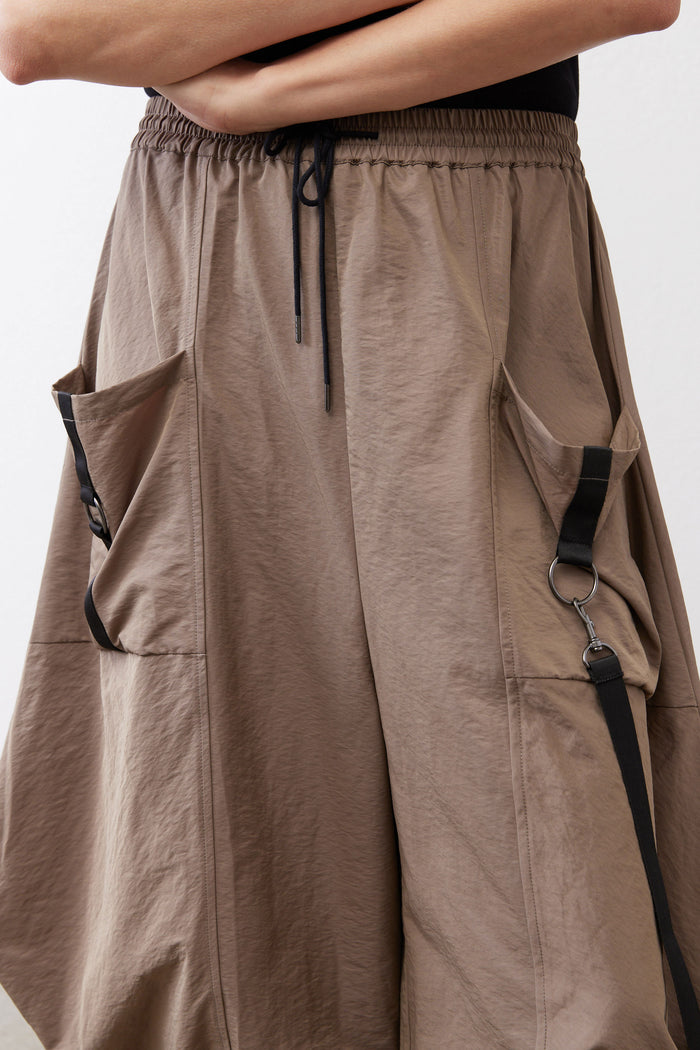 Walnut wide-leg parachute pants with elastic waist, drawstring, and side cargo pockets