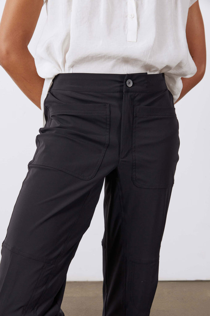 Black slim pants front view with side pocket seams and button fly