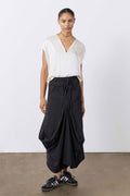 Black midi skirt with drawstring waist and roomy cargo pockets, flowing draped hem
