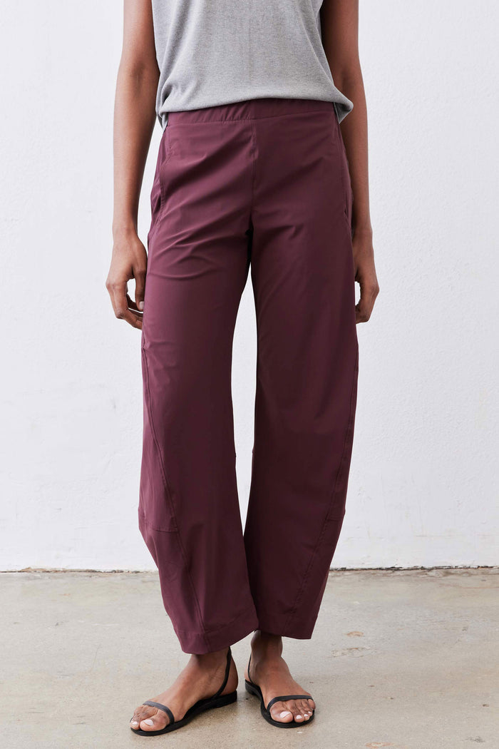 Aubergine work pants with relaxed wide-leg silhouette and elastic waist, ankle-length hem