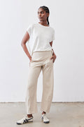Light beige work pants on model, relaxed straight fit with elastic waistband