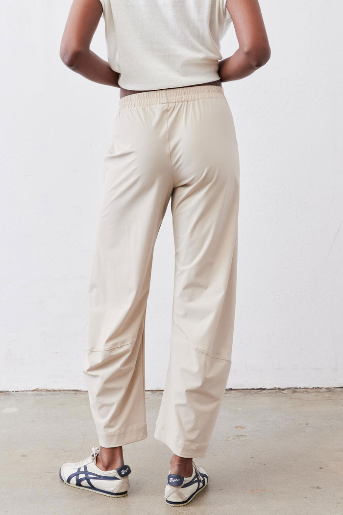 Light beige work pants with relaxed straight legs and elastic waistband