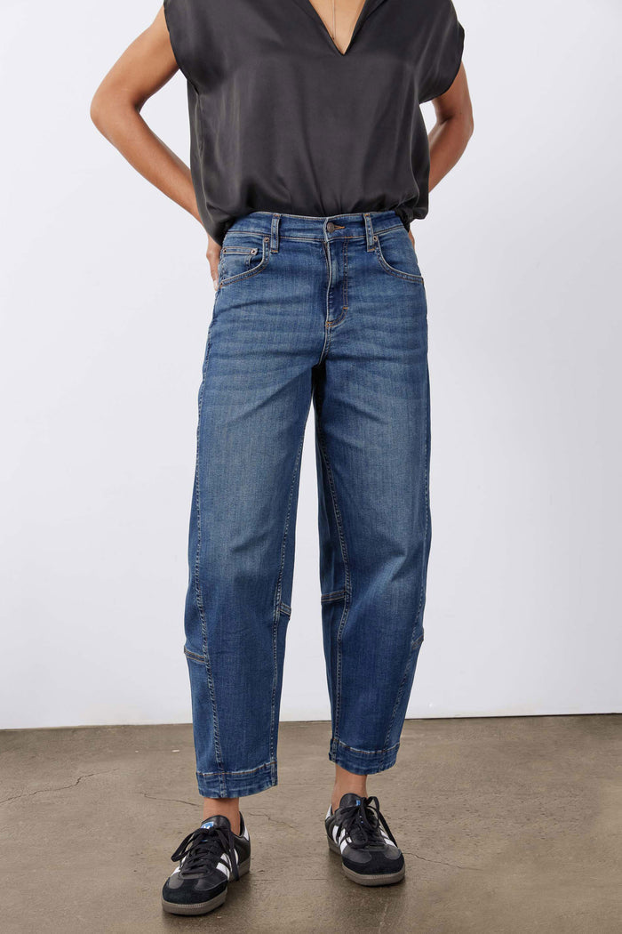 Indigo barrel-leg jeans with mid-rise waist, tapered-to-cuff leg opening, and five pockets
