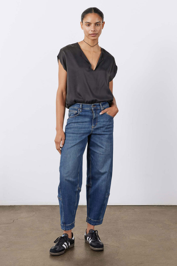 Indigo barrel-leg jeans with mid-rise waist, relaxed straight legs, and cuffed hems