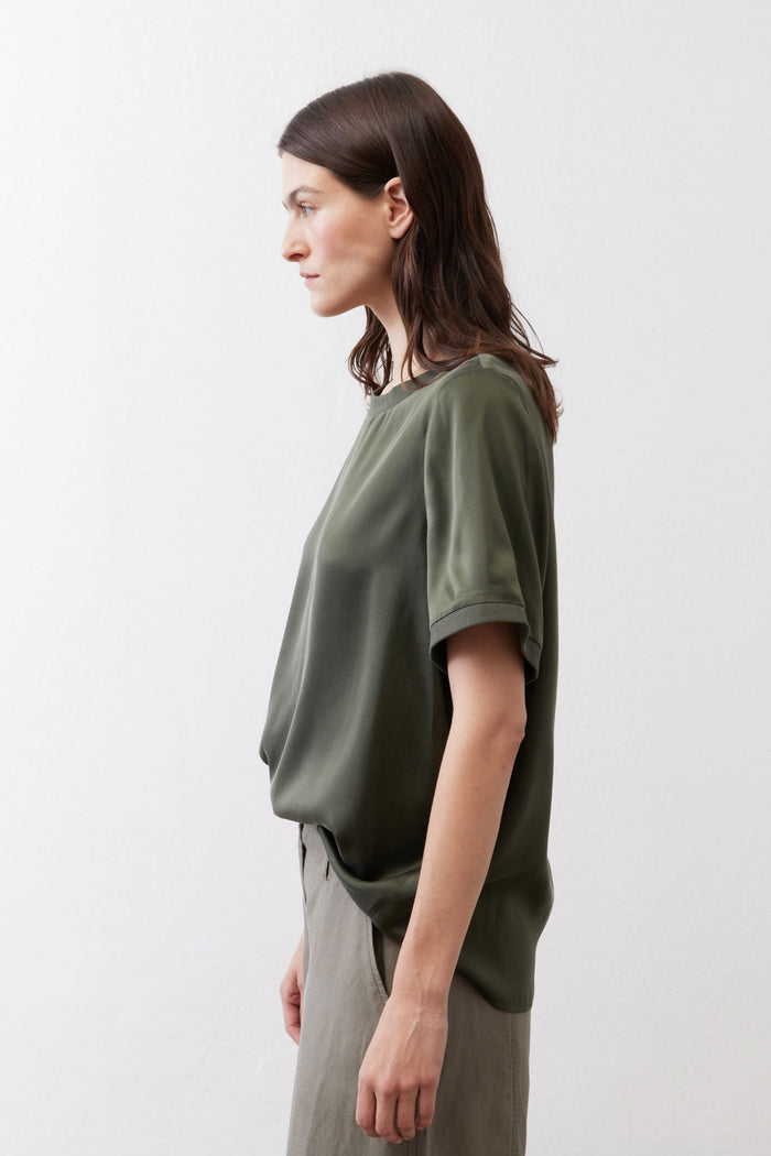 Relaxed forest green silk crew-neck top, side view, short sleeves