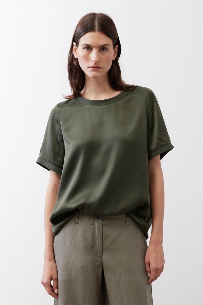Relaxed forest green silk crew-neck top with short sleeves, front view