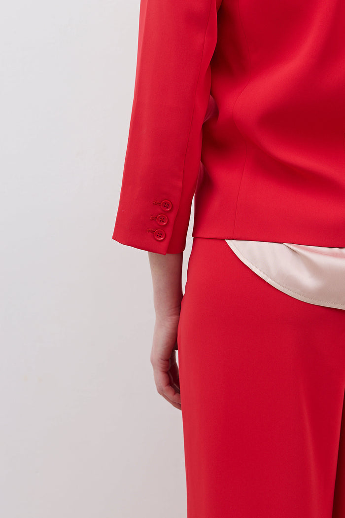 Tomato red blazer sleeve with buttoned cuff and welt seam detail