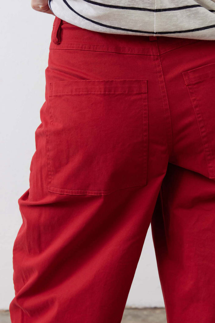Scarlet twill pants close-up of front pockets and relaxed leg seam