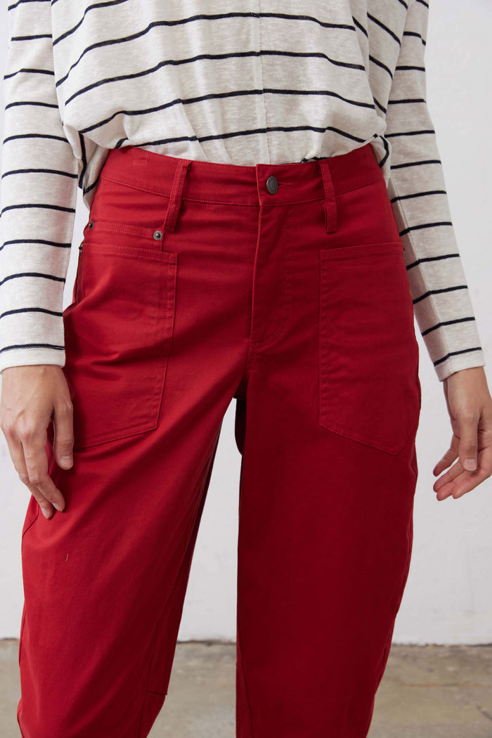 Scarlet twill pants close-up: waistband with belt loops and buttoned front