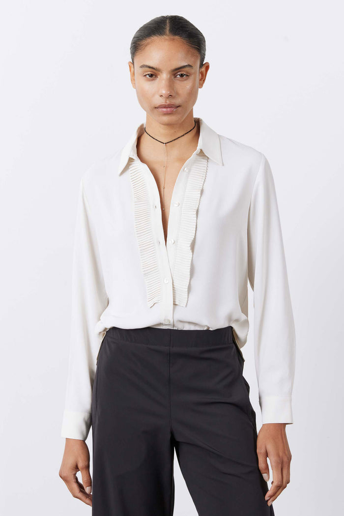 Off-white tux-style blouse with pointed collar, button front, pleated vertical trim