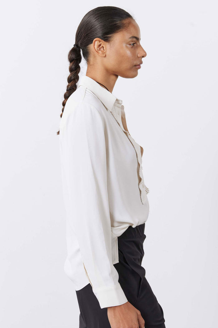 Off-white blouse with pointed collar, button front, long sleeves, pleated trim detail