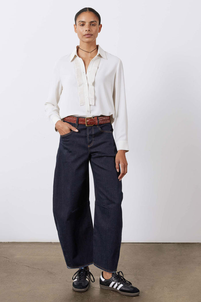 Off-white tux-style blouse with pointed collar, button front, and pleated vertical trim