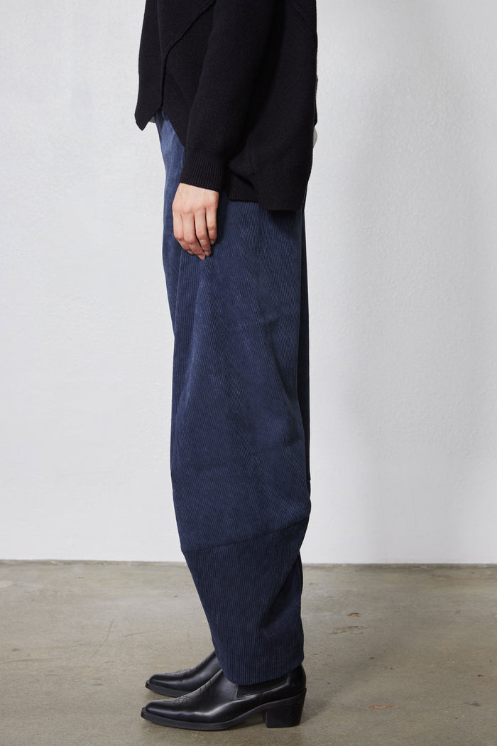 Blue corduroy pants with relaxed straight leg and roomy barrel silhouette