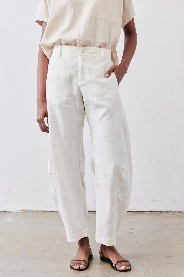 Vintage white linen pants with front pleats, relaxed tapered leg, cuffed hem
