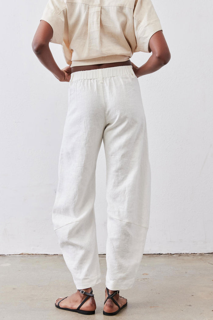 Vintage white linen pants with elastic waist and relaxed tapered legs