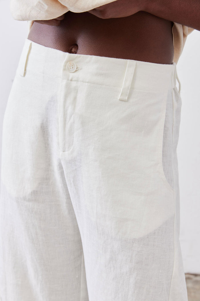 Vintage white linen pants close-up: elastic waist, button closure, side pockets
