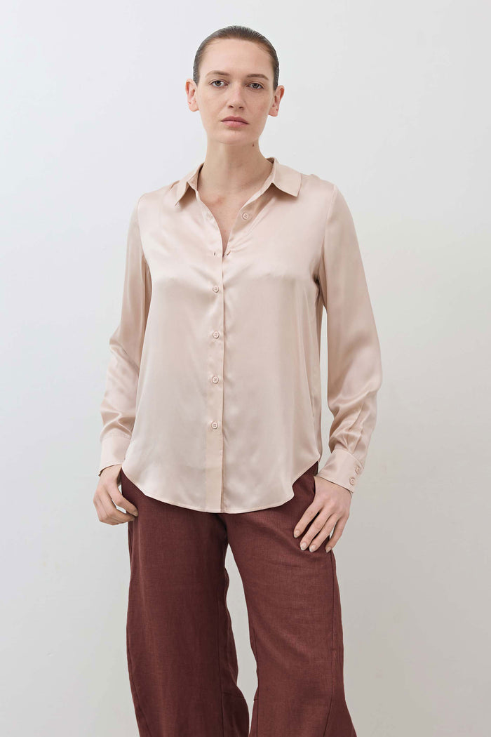 Peach blush silk button-down top, long sleeves, visible front buttons and collar