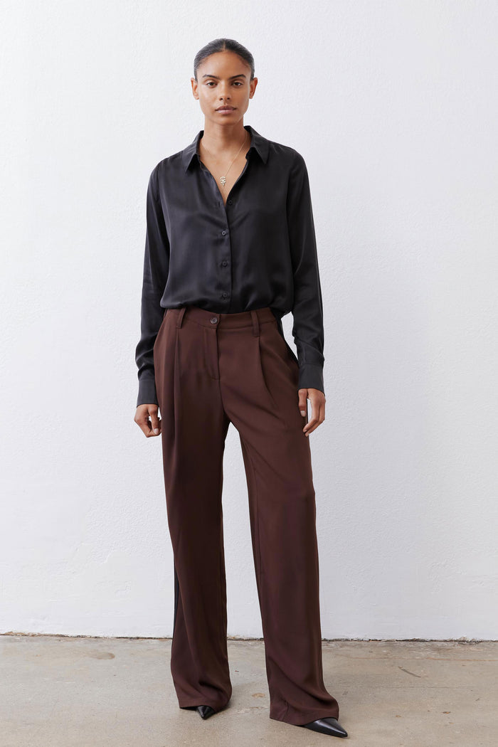 Black silk button-down top with pointed collar and button front, relaxed fit