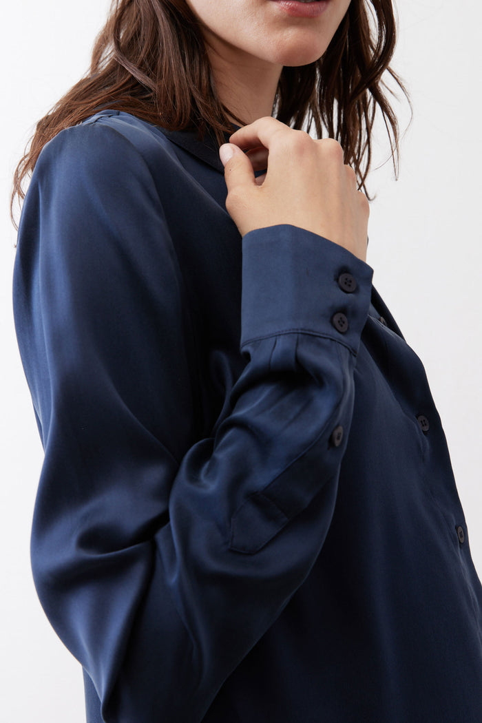 Dark blue silk button-down top close-up: collar and dark buttons