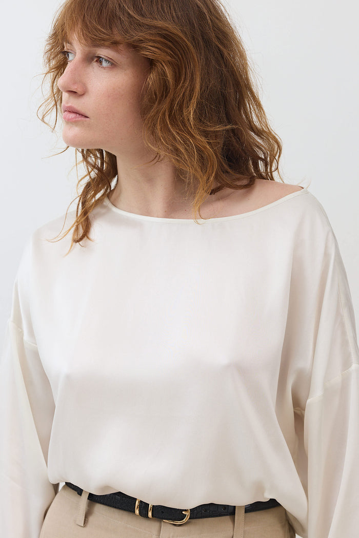 Ivory silk blouse with relaxed scoop back, long sleeves, cinched hem at waist
