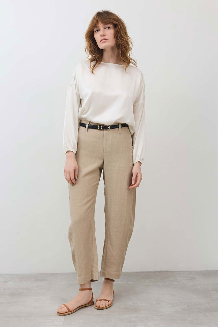 Ivory silk blouse with loose long sleeves and scoop neck, cinched hem at waist