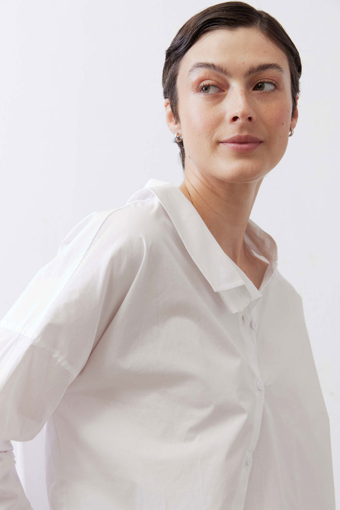 White button-down top close-up at upper chest with pointed collar