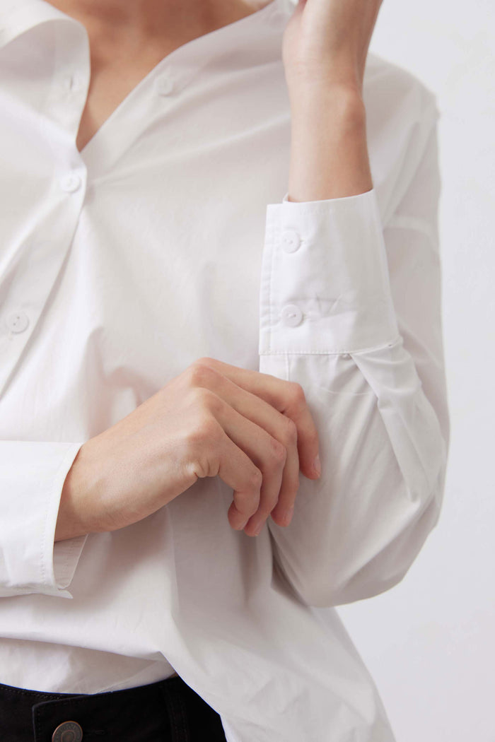 White button-down top sleeve detail with cuff buttons and folded placket