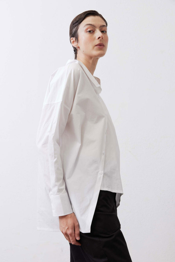 White button-down top in side view with button front and long sleeves