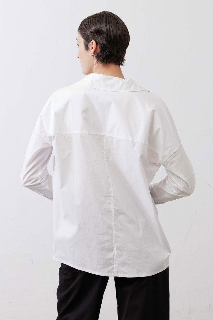 White button-down top from back view with collar and long sleeves